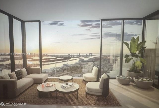 This rendering shows a modern living room with floor-to-ceiling windows overlooking a coastal city view — 300 N Biscayne Blvd. # 8502, Miami FL 33132, MIAMI, FL