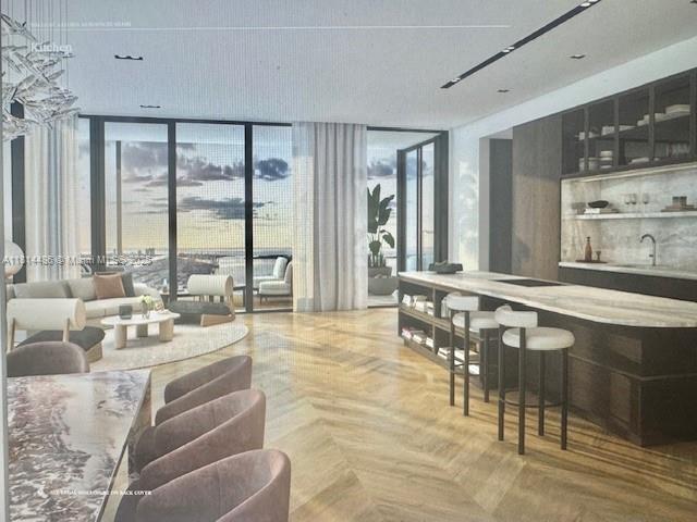 This is a rendering of a modern kitchen and living area with herringbone wood floors — 300 N Biscayne Blvd. # 8502, Miami FL 33132, MIAMI, FL