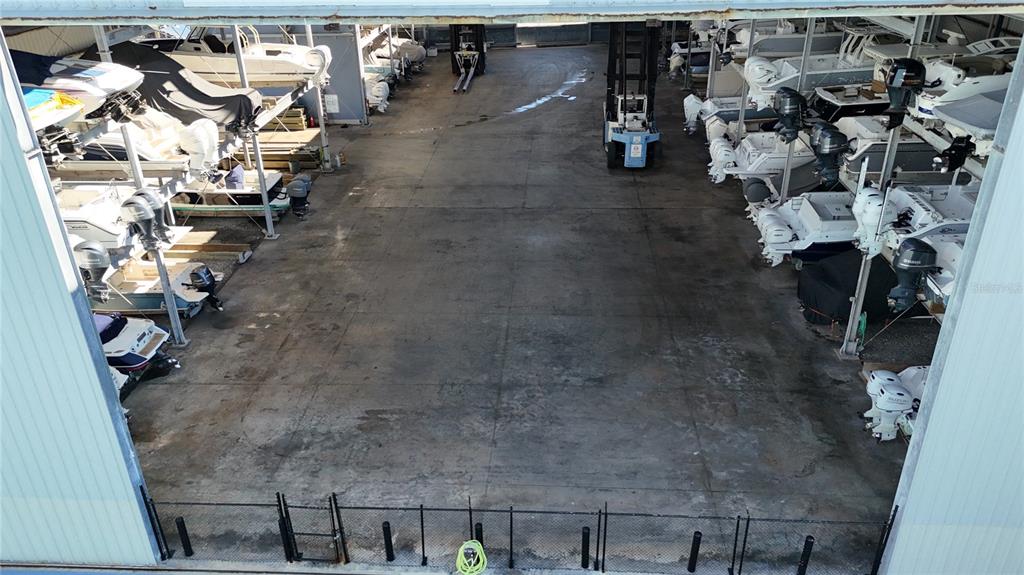 An open-air boat storage facility features concrete flooring and rows of stacked watercraft — 100 CIRCUIT ROAD UNIT N93, NOKOMIS, FL