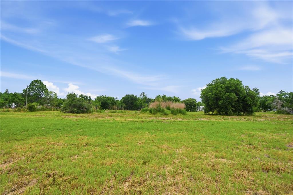 An aerial map shows a highlighted parcel of land with a pond and wooded areas — 11111 KO DRIVE, LAKELAND, FL