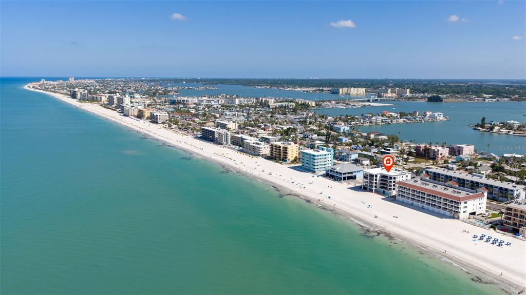 An aerial view of a beachfront condo building marked with a red location pin — 14048 GULF BOULEVARD UNIT 201, MADEIRA BEACH, FL