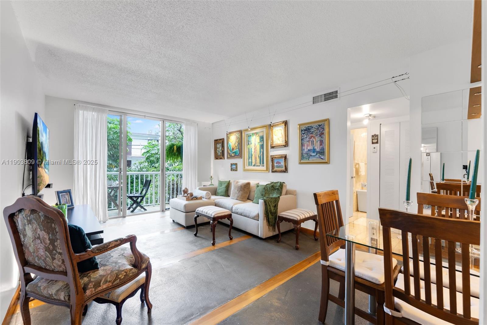 A living and dining area features a sofa, patterned armchairs, and a glass dining table — 3661 SW 9th Ter # 207, Miami FL 33135, MIAMI, FL