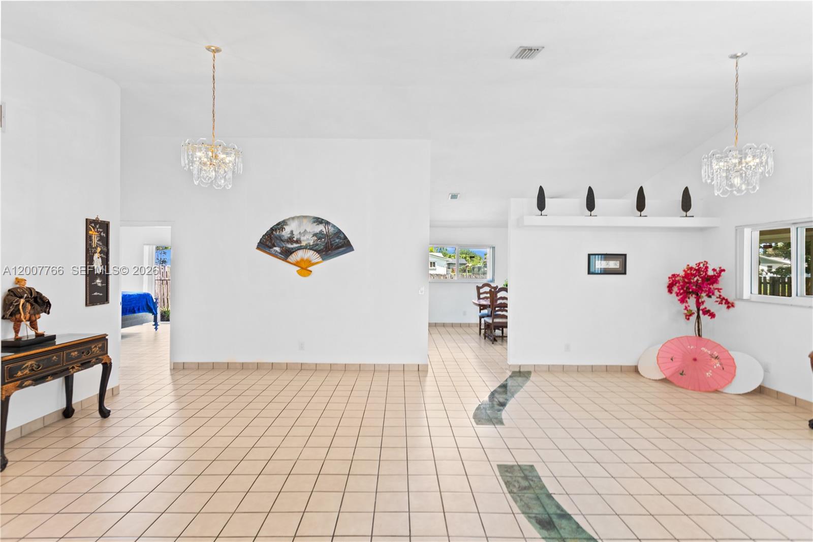 A tiled living area features two crystal chandeliers, decorative wall fans, and a dining space — 6450 SW 13th St, Plantation FL 33317, PLANTATION, FL