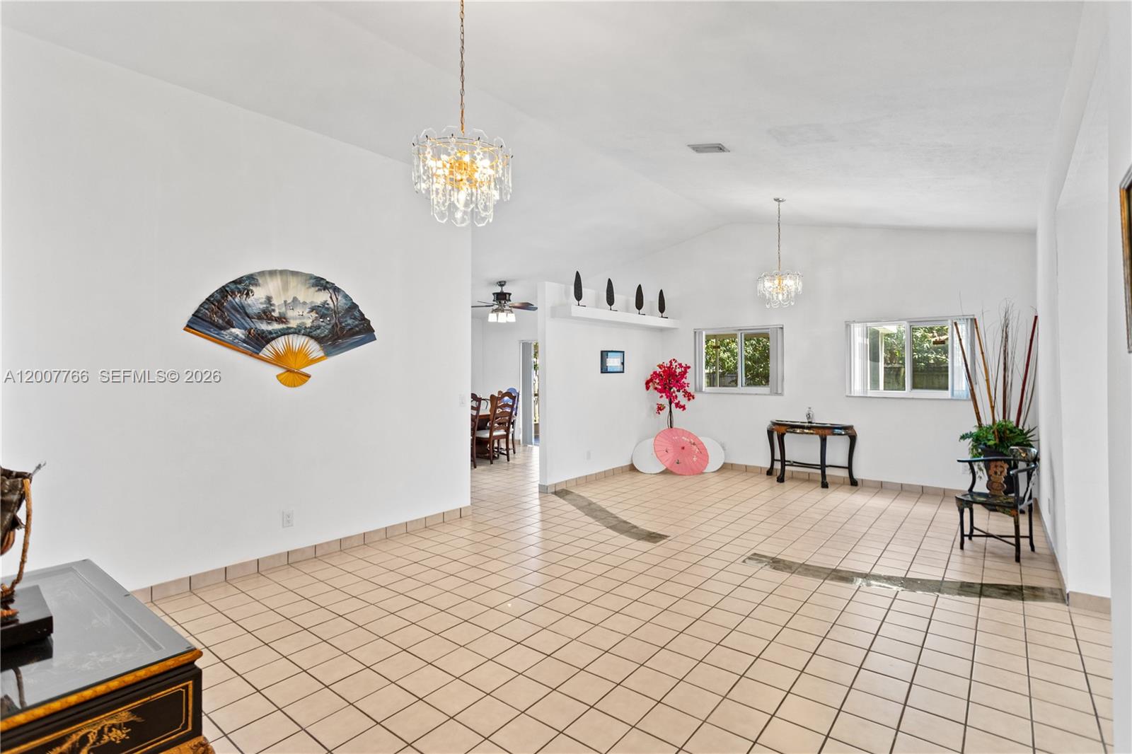 A spacious room features white walls, tiled flooring, two crystal chandeliers, and Asian-inspired decor — 6450 SW 13th St, Plantation FL 33317, PLANTATION, FL