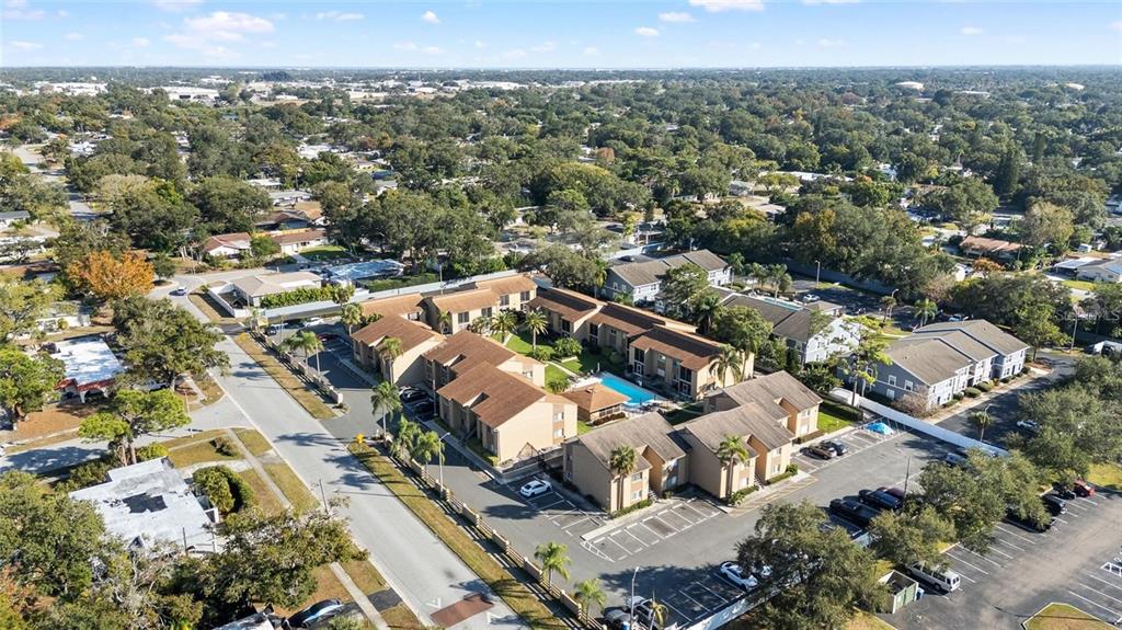 An aerial view shows a multi-building apartment complex with a central pool and parking lots — 1589 GREENLEA DRIVE UNIT 3, CLEARWATER, FL