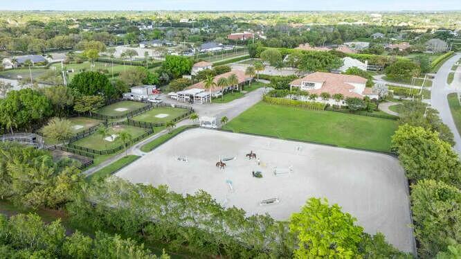 An aerial view of an equestrian property featuring a large riding arena and stable buildings — 14471 Equestrian Way, Wellington FL 33414, WELLINGTON, FL