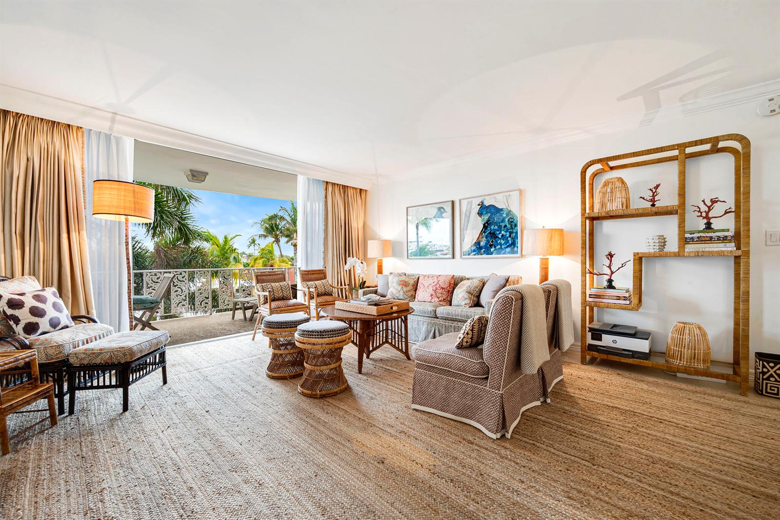 A living room features rattan furniture, a large area rug, and a balcony with palm trees — 227 Australian Avenue # 3e, Palm Beach FL 33480, PALM BEACH, FL