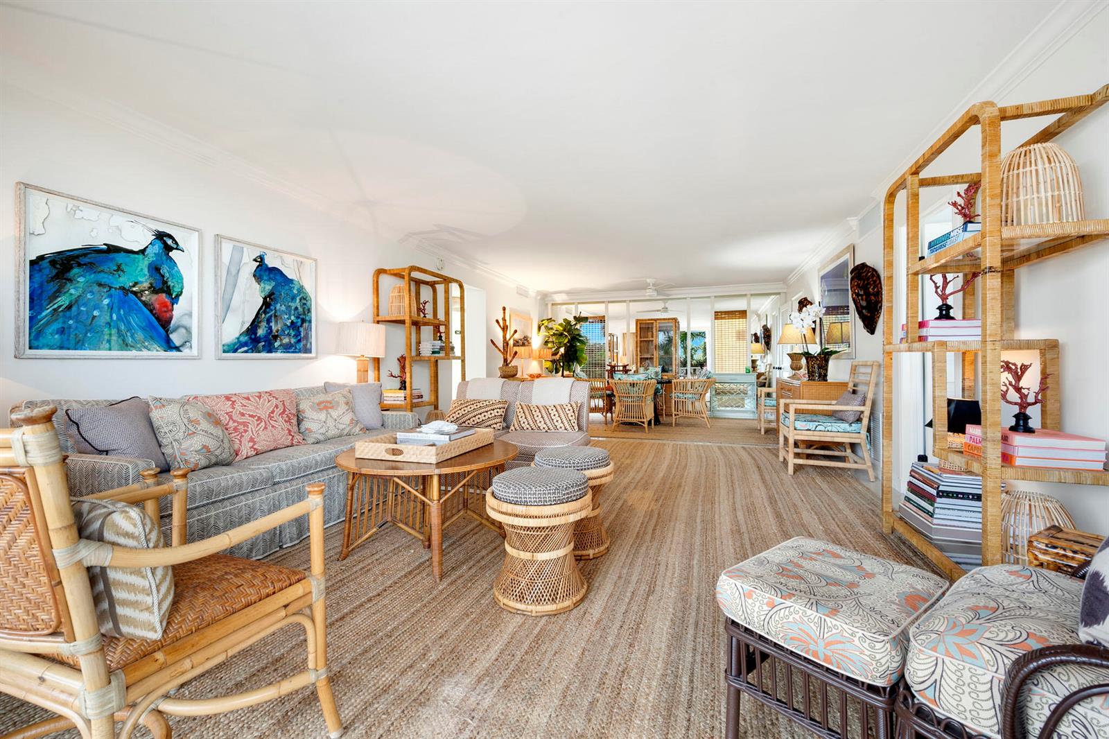 A living room features rattan furniture, patterned upholstery, a jute rug, and two peacock paintings — 227 Australian Avenue # 3e, Palm Beach FL 33480, PALM BEACH, FL