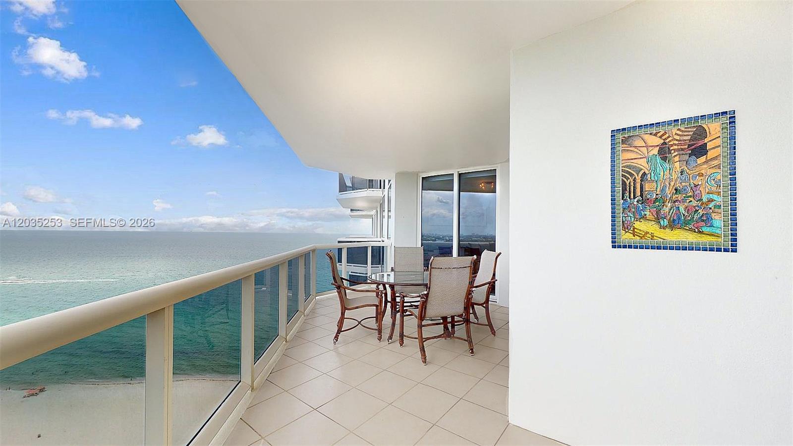 A balcony with outdoor furniture overlooks the ocean under a blue sky — 4779 Collins Ave # 2708, Miami Beach FL 33140, MIAMI BEACH, FL