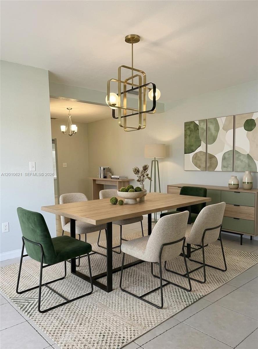 A dining room features a wooden table, mixed seating, and a modern geometric chandelier — 2412 SW 11th St # 1, Miami FL 33135, MIAMI, FL