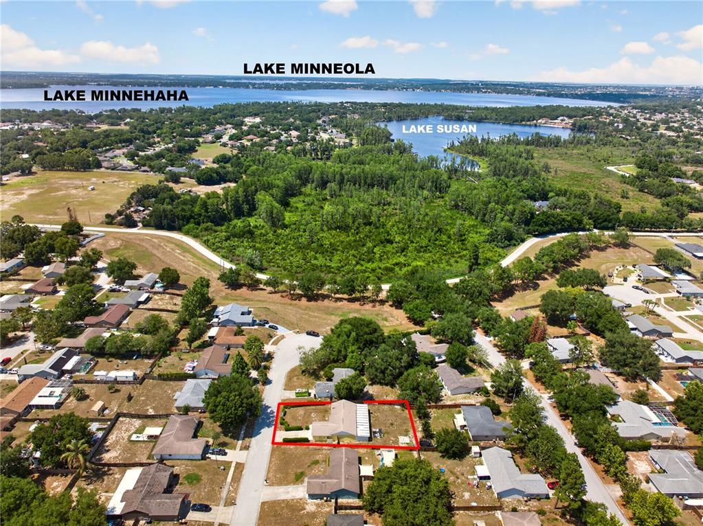 An aerial view shows a residential neighborhood with a highlighted house near several lakes — 10810 CRESCENDO LOOP, CLERMONT, FL