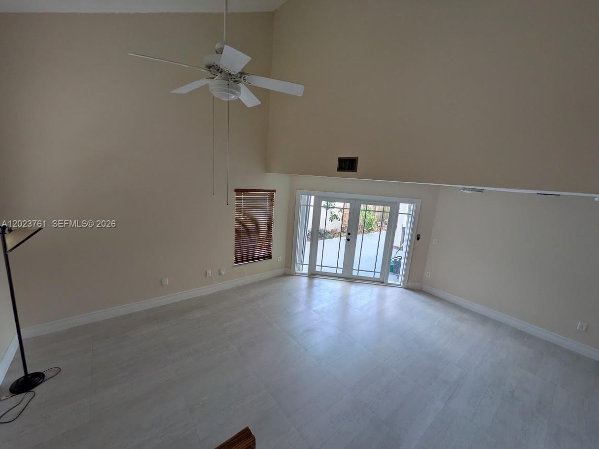 A kitchen features wood cabinets, stainless steel appliances, a tiled backsplash, and white countertops — 11740 SW 102nd St, Miami FL 33186, MIAMI, FL