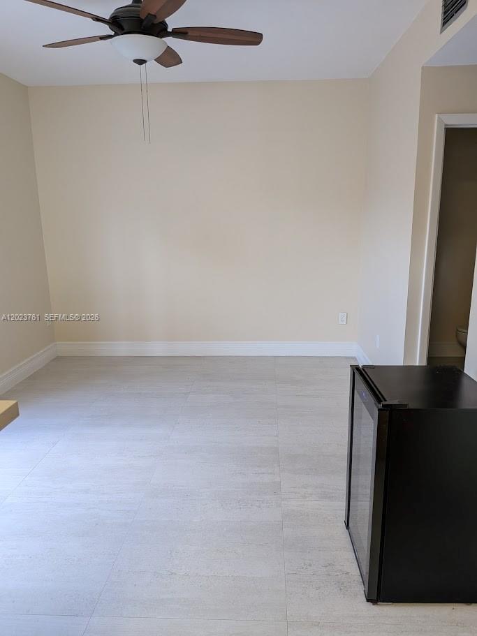 This bedroom features a queen bed, an attached bathroom, and a ceiling fan — 11740 SW 102nd St, Miami FL 33186, MIAMI, FL