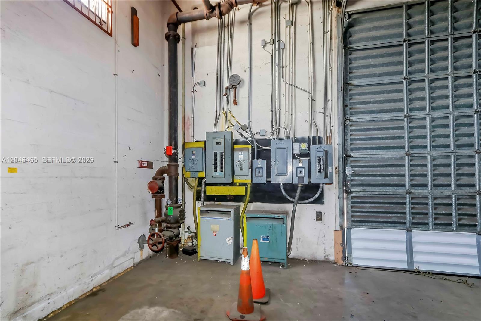 An industrial room features a large fire sprinkler riser and multiple electrical panels on walls — 540 W 20th St, Hialeah FL 33010, HIALEAH, FL