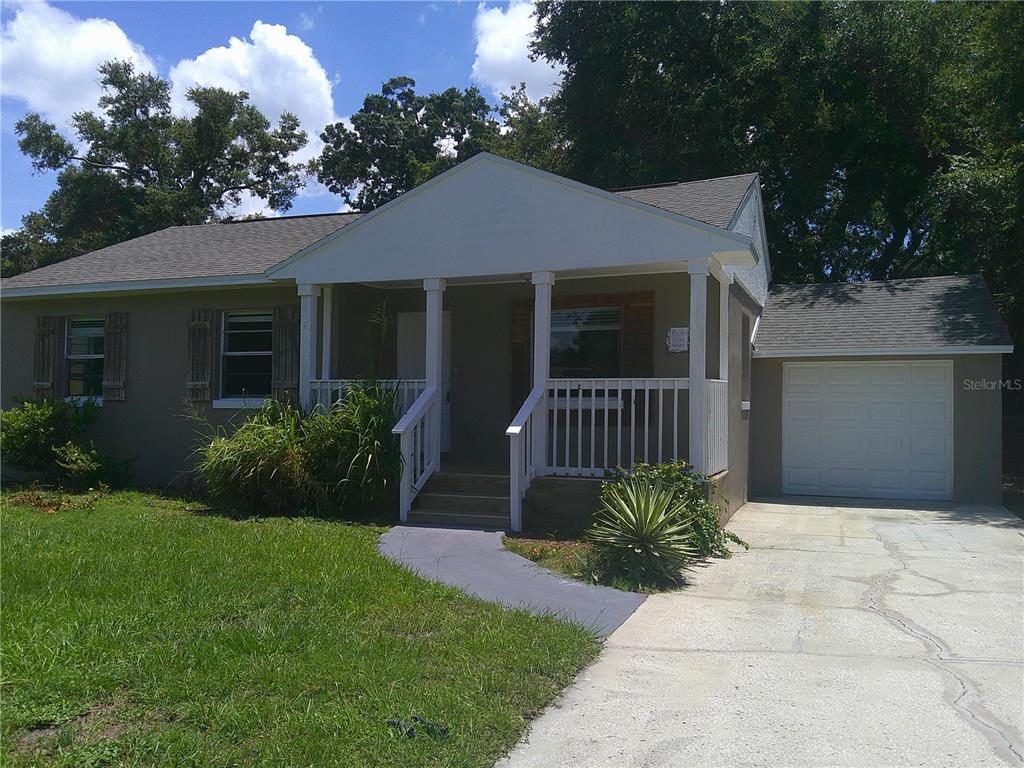 A single-story house with a front porch, attached garage, and a concrete driveway — 1241 NICHOLSON STREET, CLEARWATER, FL