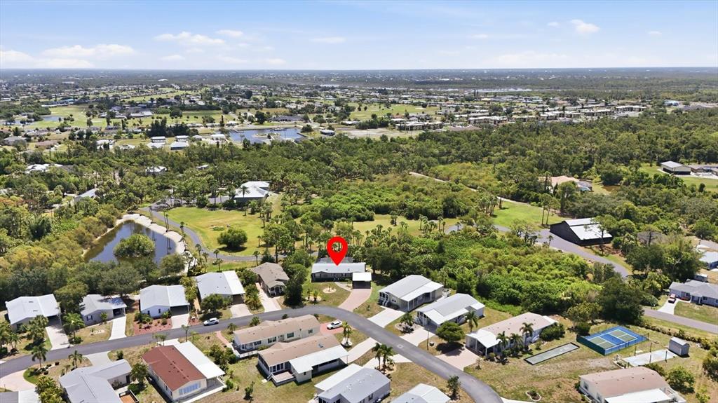 An aerial view shows a residential neighborhood with a red location pin over a house — 9158 PINEHAVEN WAY, ENGLEWOOD, FL