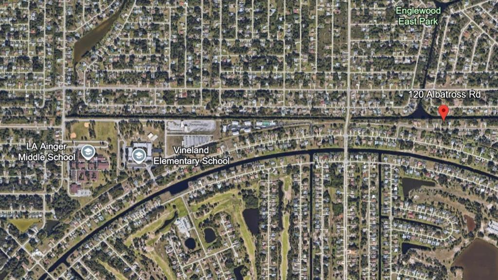 This is an aerial map showing a residential neighborhood with schools and a marked property — 120 ALBATROSS ROAD, ROTONDA WEST, FL