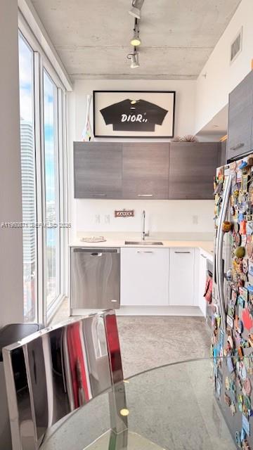 A modern kitchen features white lower cabinets, dark upper cabinets, and floor-to-ceiling windows — 151 SE 1st St # 3010, Miami FL 33131, MIAMI, FL