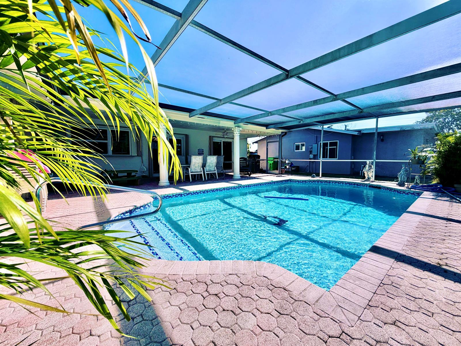 A screened-in swimming pool with a brick paver deck and a covered patio area — 11441 NW 29th Manor, Sunrise FL 33323, SUNRISE, FL