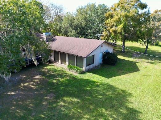 An aerial view of a single-story house with a brown roof and large windows — 4705 KISSIMMEE PARK ROAD, ST CLOUD, FL