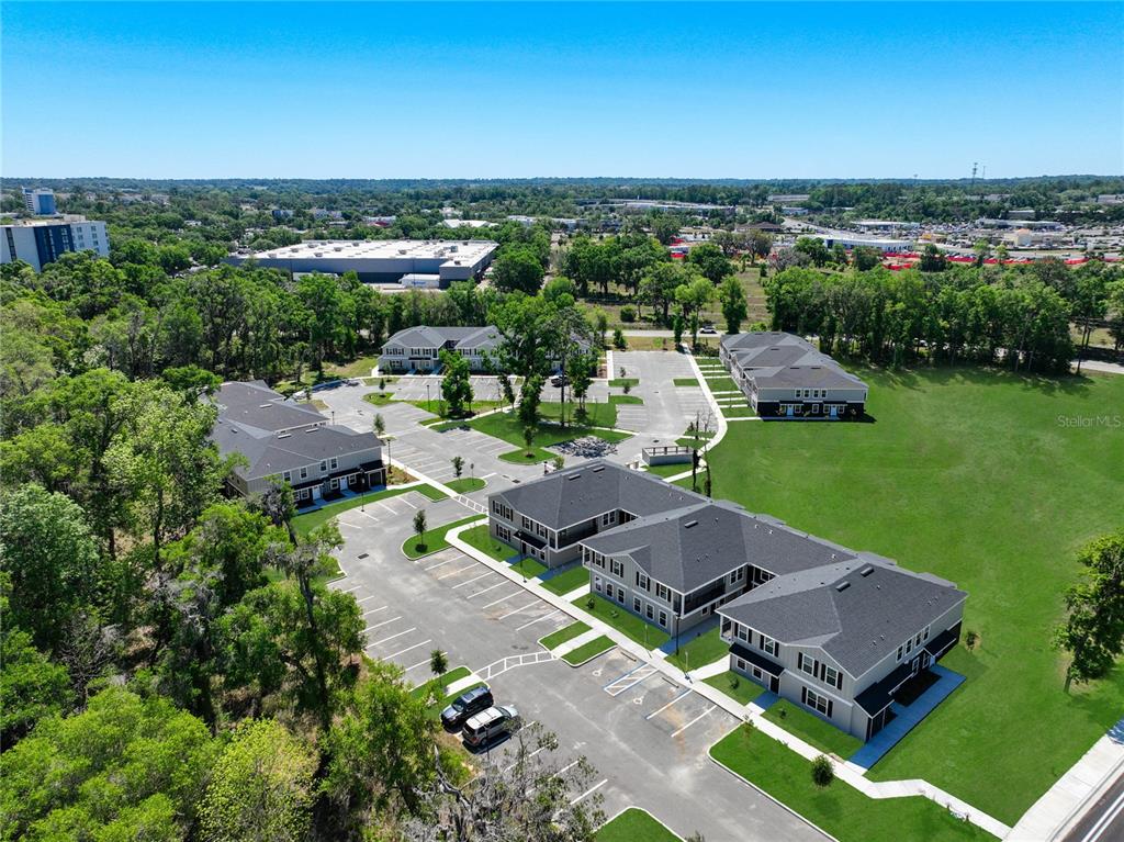 An aerial view shows several multi-story apartment buildings surrounded by parking lots and green space — 3821 SW 43RD COURT, OCALA, FL