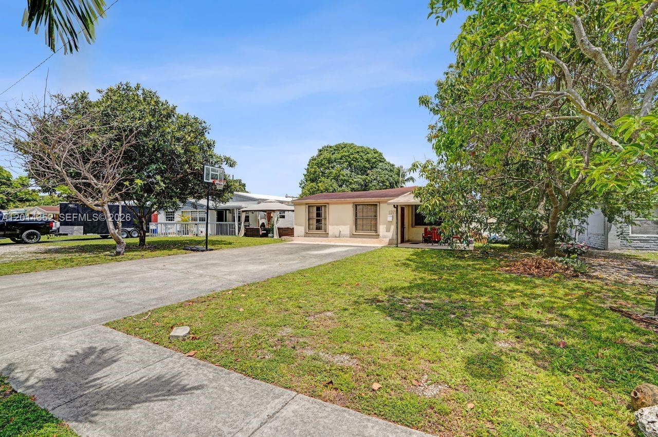 A single-story house with a concrete driveway and a basketball hoop in the front yard — 1379 NE 177th St, North Miami Beach FL 33162, NORTH MIAMI BEACH, FL