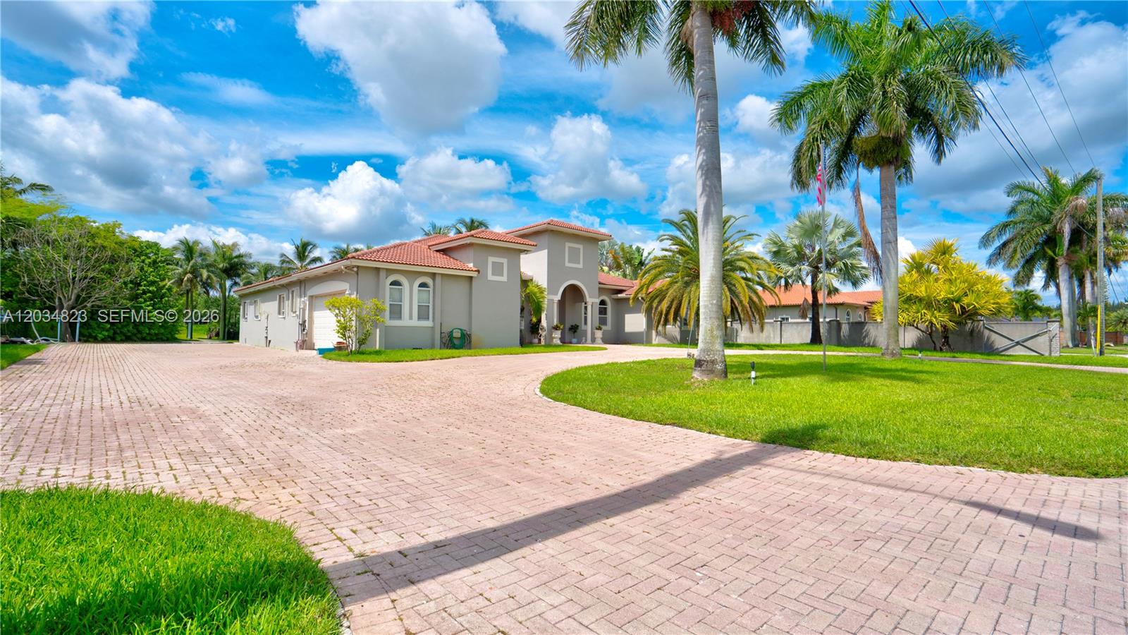 A single-story house with a terracotta roof and a large brick-paved driveway — 9810 NW 137th St, Hialeah Gardens FL 33018, HIALEAH GARDENS, FL