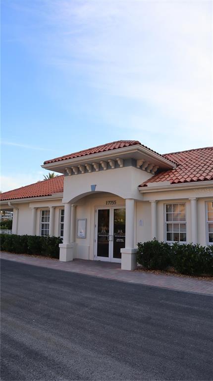 A single-story building with a tiled roof and a covered entryway featuring white columns — 108 FOREST HILLS DRIVE, REDINGTON SHORES, FL