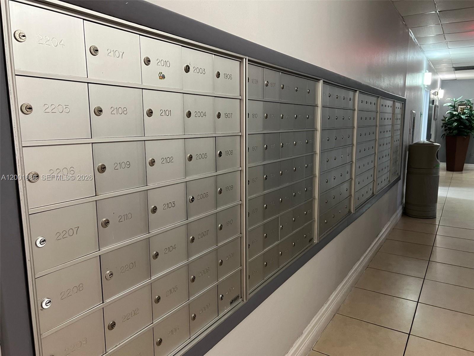 A hallway features a long wall of metal mailboxes with numbered slots — 850 N Miami Ave # 1806, Miami FL 33136, MIAMI, FL
