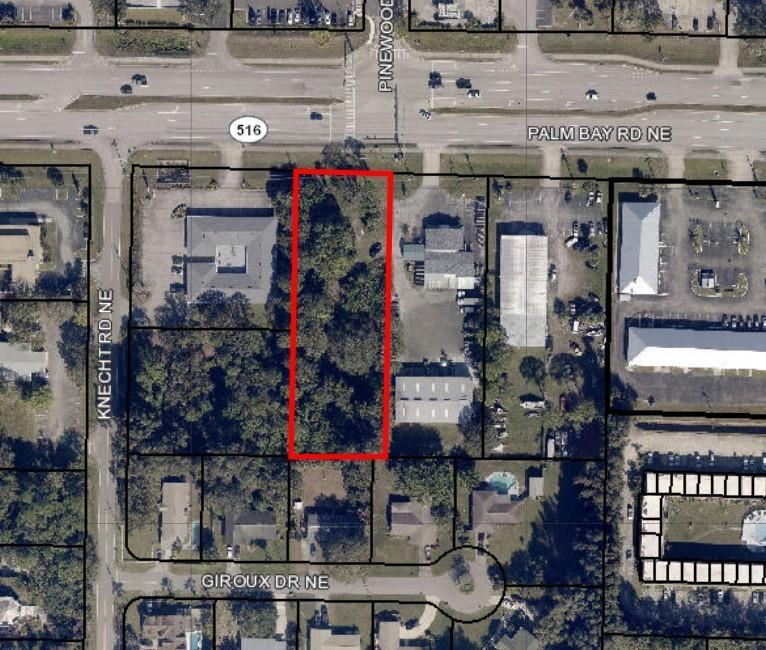 This aerial map shows a rectangular, wooded lot outlined in red near a major road — 1922 NE Palm Bay Road, Palm Bay FL 32905, PALM BAY, FL