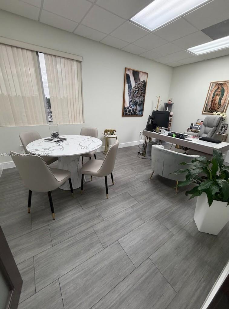 An office space features a marble-topped round table, four chairs, and a desk area — 8485 Bird Rd # 301, Miami FL 33155, MIAMI, FL