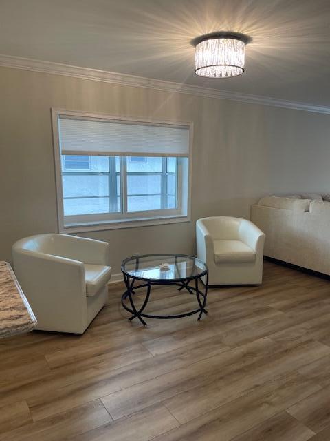 A living room features two white armchairs, a glass coffee table, and wood-look flooring — 5655 Via Delray Boulevard, Delray Beach FL 33484, DELRAY BEACH, FL