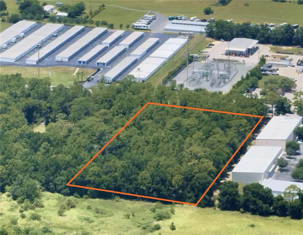 An aerial view shows a wooded, rectangular plot of land outlined in orange — SW 60TH AVENUE, OCALA, FL