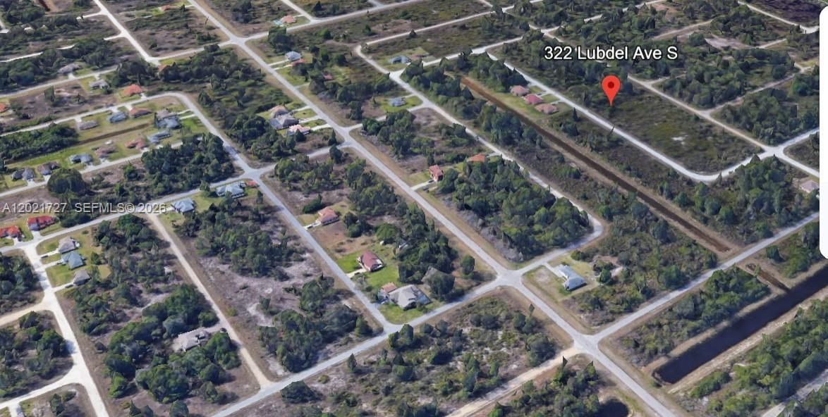 This aerial map view shows a vacant, wooded residential lot located along a street — 322 Lubdel Ave S, Lehigh Acres FL 33974, LEHIGH ACRES, FL