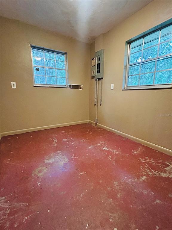 A dining room with light green walls, white wainscoting, tile flooring, and a chandelier — 7532 SW 122ND STREET, GAINESVILLE, FL