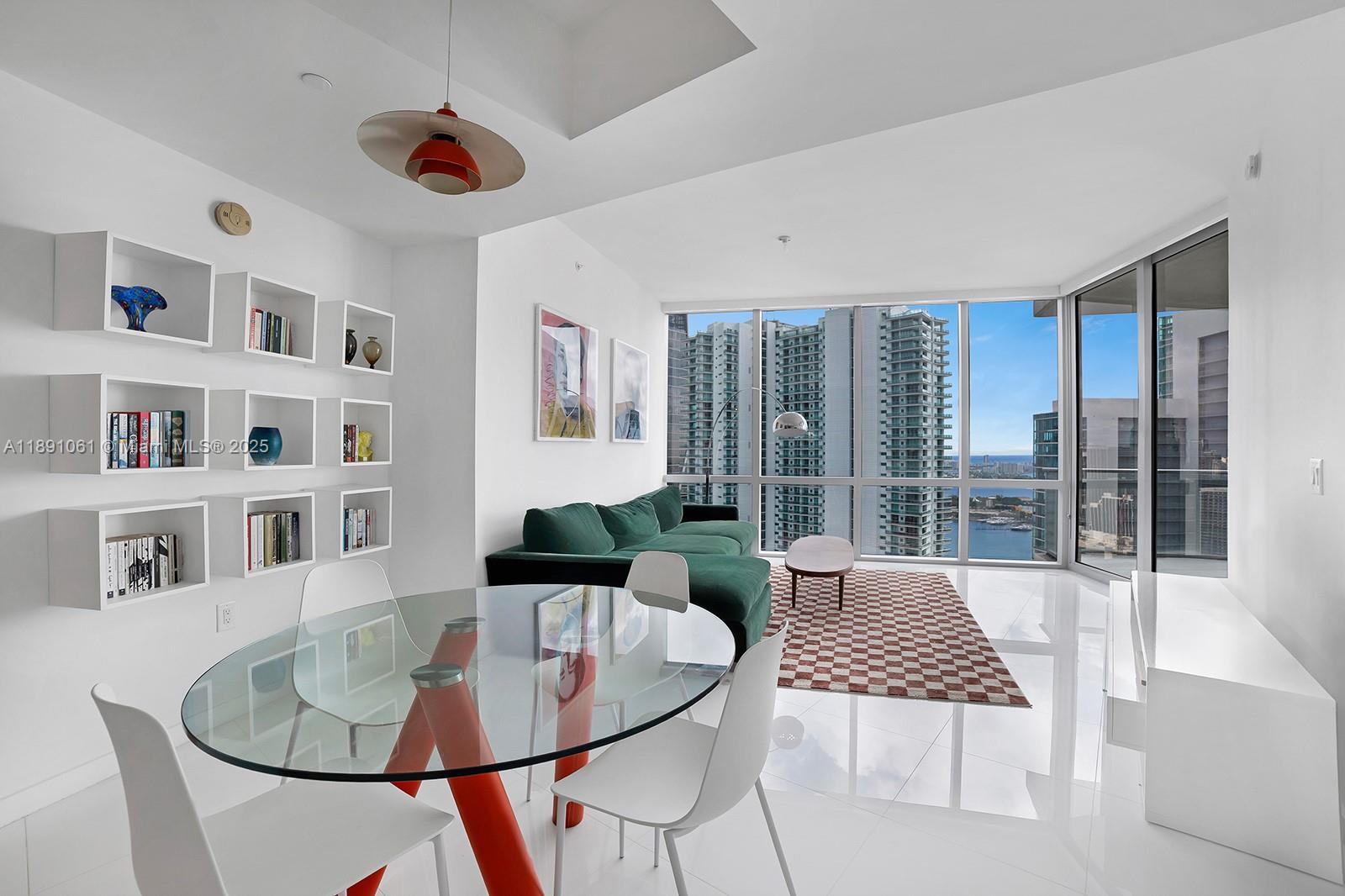 A modern living and dining area features white walls, a glass table, and floor-to-ceiling windows — 851 NE 1st Ave # 4403, Miami FL 33132, MIAMI, FL
