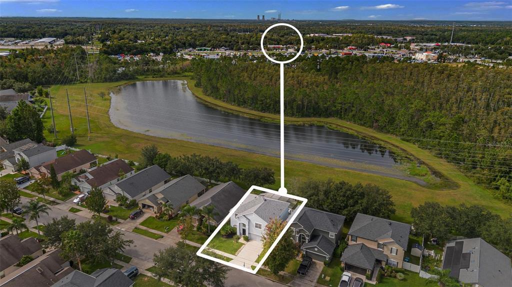 An aerial view shows a suburban house with a white outline and a pond behind — 1892 HAMMOCK MOSS DRIVE, ORLANDO, FL