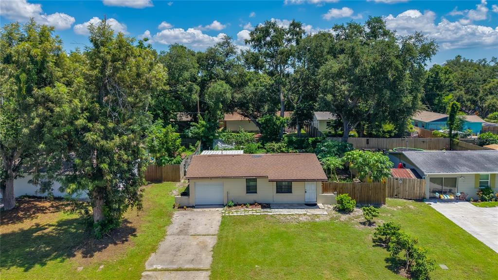 A single-story house with a brown roof, white siding, and a concrete driveway — 8653 69TH STREET N, PINELLAS PARK, FL
