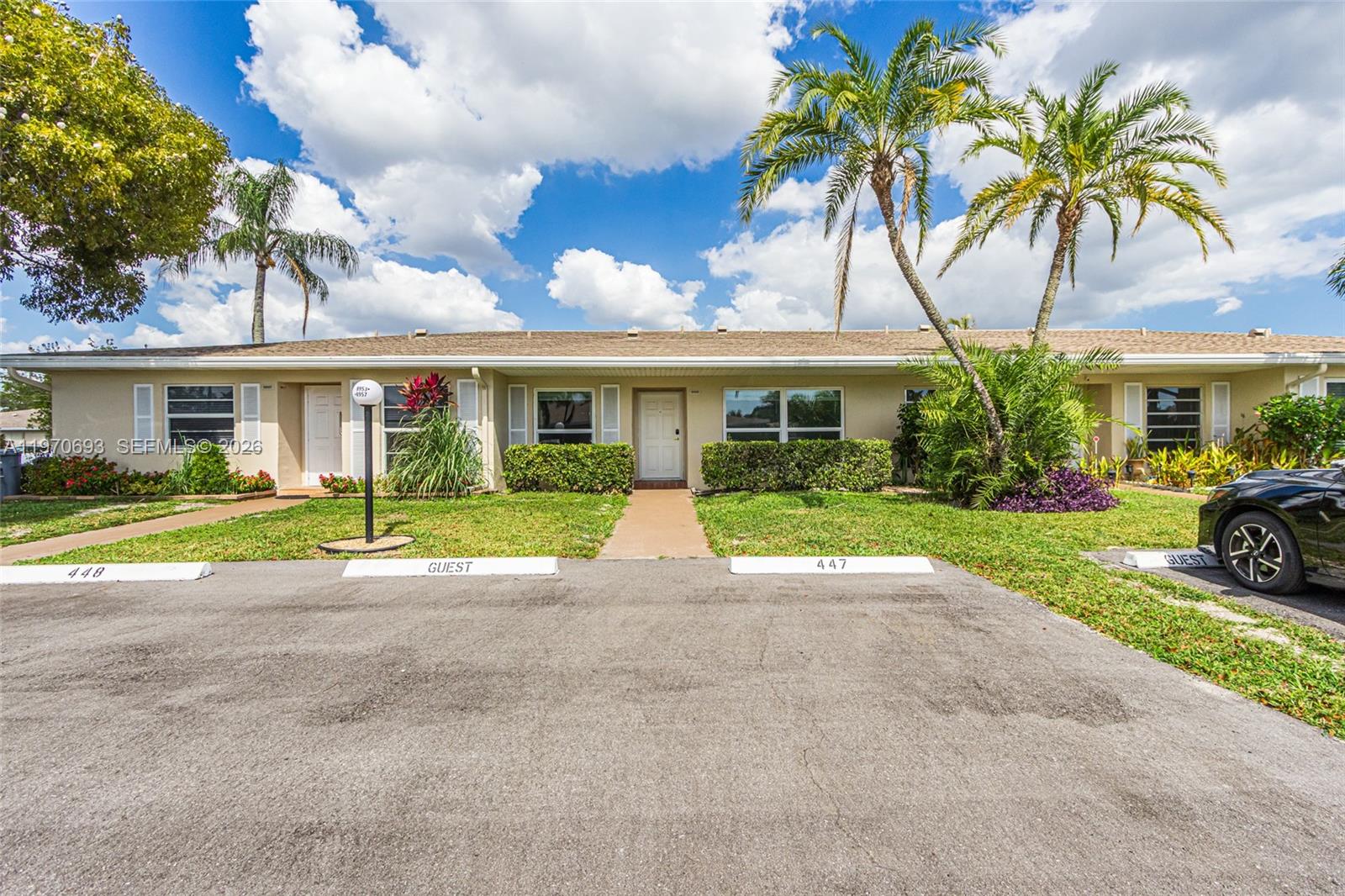 A single-story residential building with a parking lot and palm trees in front — 8953 Warwick Dr # 8953, Boca Raton FL 33433, BOCA RATON, FL