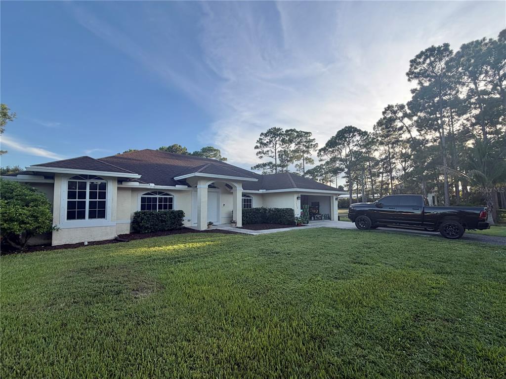 A single-story house with a tan exterior, dark roof, and a black truck parked outside — 17770 64TH PLACE N, LOXAHATCHEE, FL