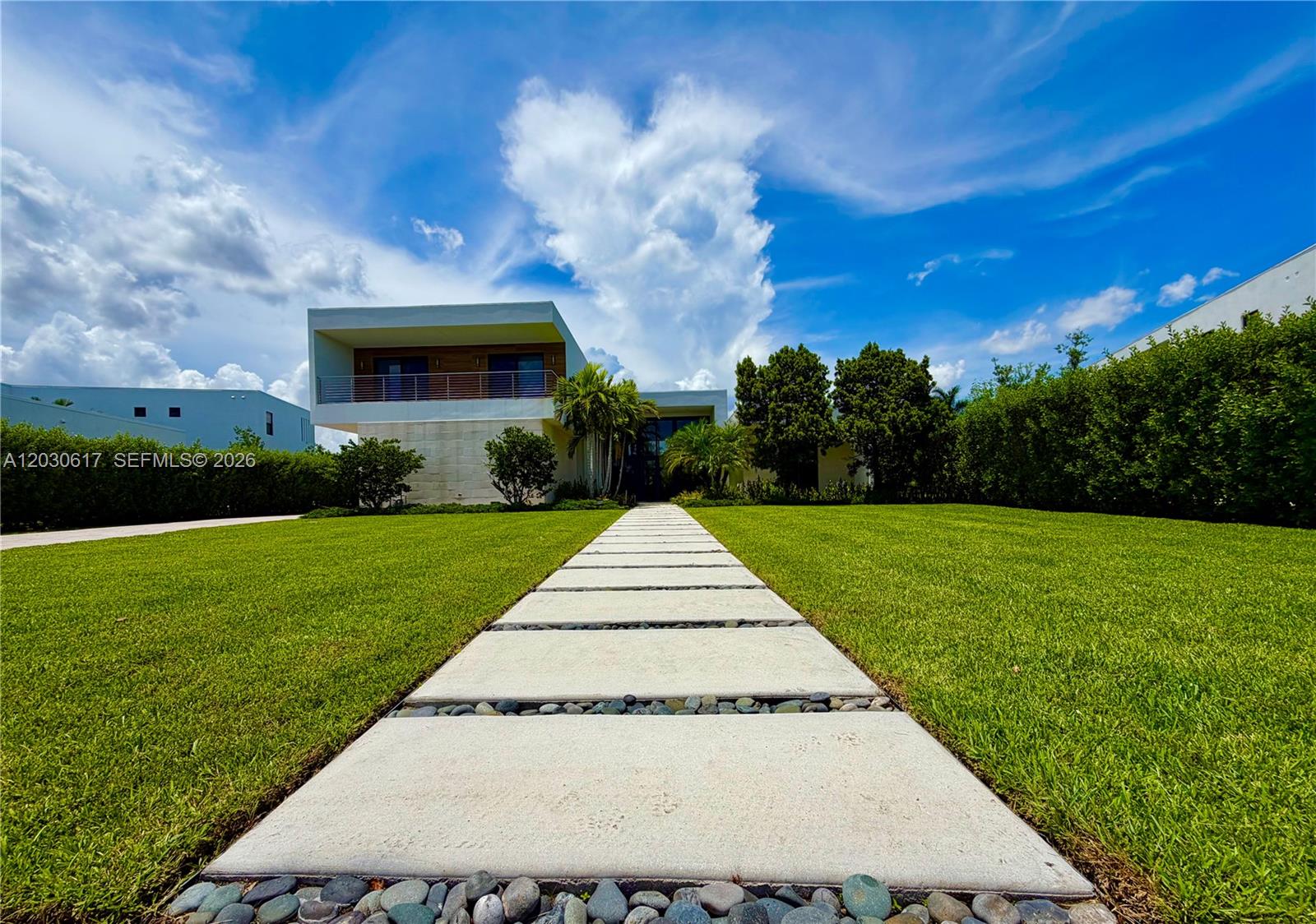 A modern two-story house features a stone facade and a concrete paver walkway through grass — 16569 Botaniko Dr N, Weston FL 33326, WESTON, FL