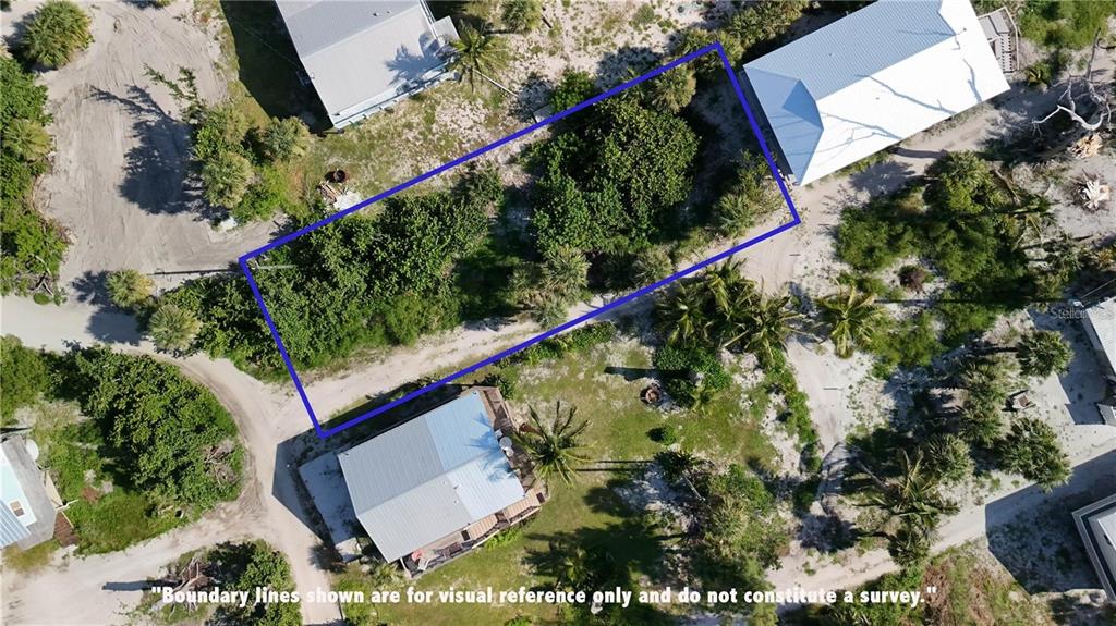 An aerial view shows a rectangular plot of land outlined in blue between two houses — 8480 LITTLE GASPARILLA ISLAND, PLACIDA, FL