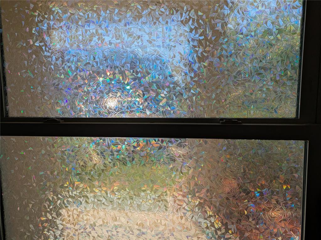 A window covered with a decorative, iridescent, stained-glass style privacy film — 2115 NE 42nd Court # 104N, Lighthouse Point FL 33064, LIGHTHOUSE POINT, FL