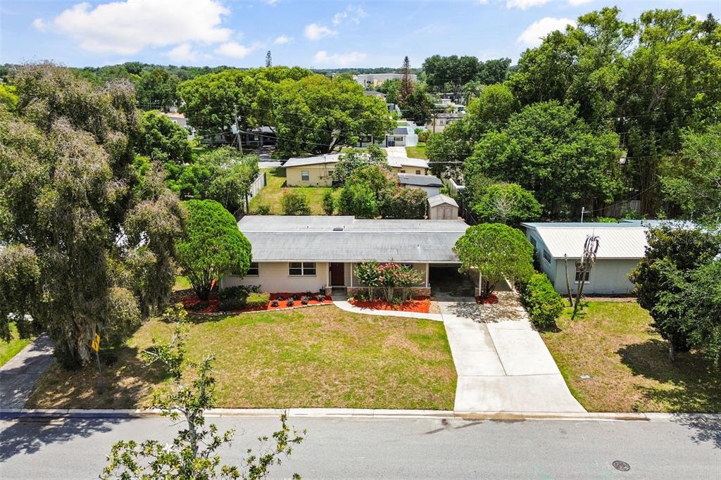 An aerial view shows a single-story house with a concrete driveway and a grassy yard — 5409 STRATEMEYER DRIVE, ORLANDO, FL