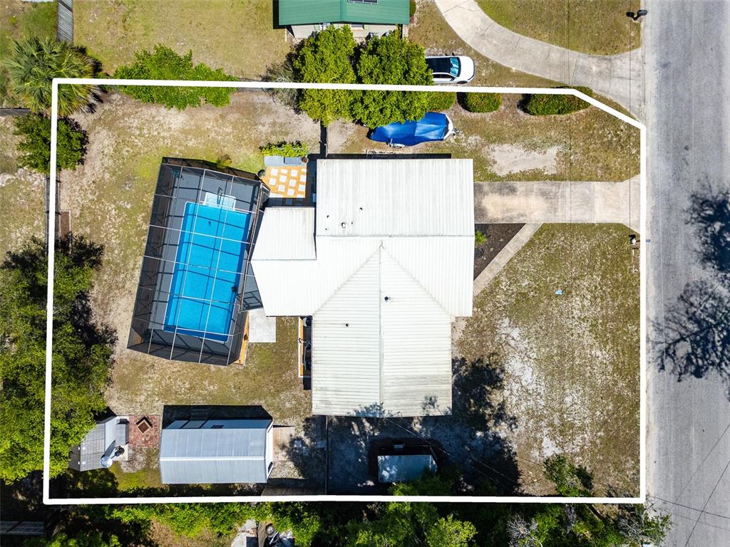 An aerial view shows a house with a screened pool, a shed, and a driveway — 1516 PROSPECT STREET, PALATKA, FL