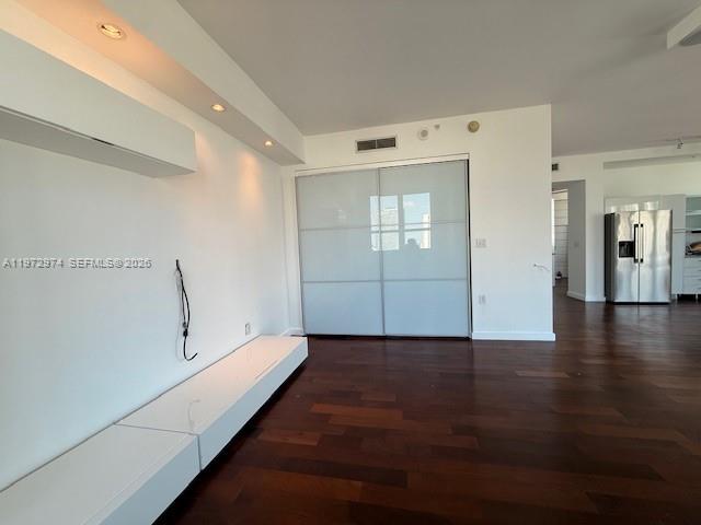 A living room features dark wood floors, a white media console, and sliding glass doors — 133 NE 2nd Ave # 3213, Miami FL 33132, MIAMI, FL