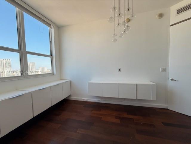 A room with dark wood floors, white built-in cabinets, and a modern glass pendant light — 133 NE 2nd Ave # 3213, Miami FL 33132, MIAMI, FL