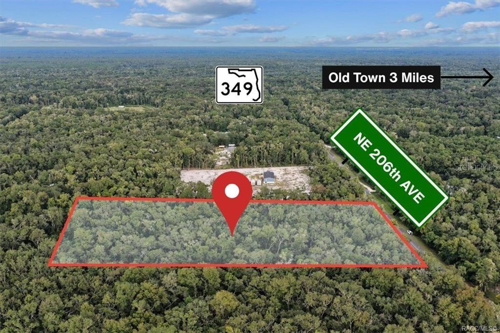 An aerial view shows a wooded lot outlined in red near a road — 0 NE 206TH AVENUE, OLD TOWN, FL