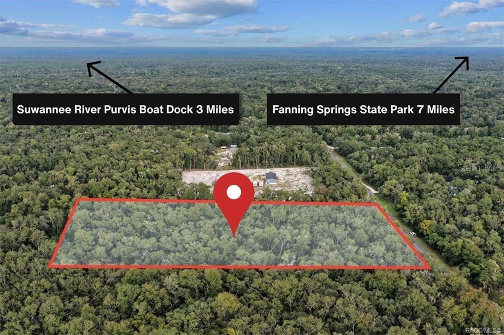 An aerial view shows a rectangular plot of land outlined in red amidst dense forest — 0 NE 206TH AVENUE, OLD TOWN, FL