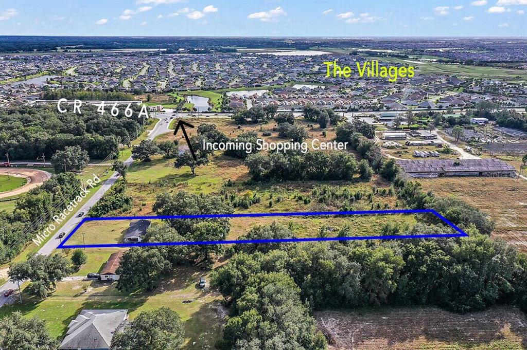 An aerial view shows a rectangular plot of land outlined in blue near a road — 35433 MICRO RACETRACK ROAD, FRUITLAND PARK, FL